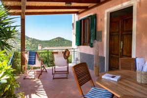a patio with chairs and a table on a balcony at Casa Gelso in Marciana