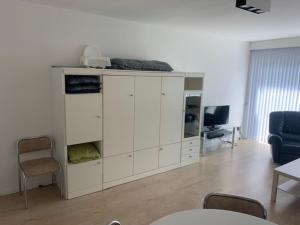 a white cabinet in a living room with a tv at Cap Horn 0205 in Koksijde