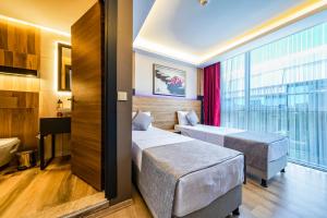 Postel nebo postele na pokoji v ubytování RUSH HOTEL İSTANBUL