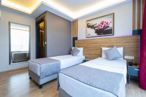 Postel nebo postele na pokoji v ubytování RUSH HOTEL İSTANBUL