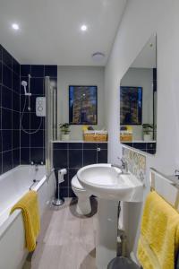 La salle de bains est pourvue d'un lavabo, de toilettes et d'une baignoire. dans l'établissement Marys Garden View North, à Jedburgh