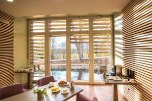 a room with a large window with wooden blinds at Château du Bost - Teritoria in Bellerive-sur-Allier