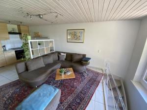 a living room with a couch and a table at Haus Höhneck 1 in Alpirsbach