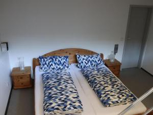 a bed with two pillows on it in a room at Haus Höhneck 1 in Alpirsbach