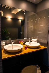 a bathroom with two sinks and a mirror at Château du Bost - Teritoria in Bellerive-sur-Allier