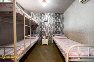 a bedroom with two bunk beds and a mural at Mamas and Papas Guesthouse and Apartments in Seoul in Seoul