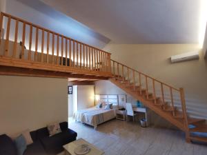 a bedroom with a bed and a wooden staircase at Sidari Waterpark in Sidari