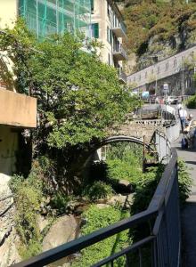 a bridge over a river next to a building at Sentieri Sul Mare in Manarola +4 photos