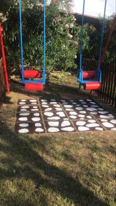 a swing set in a yard with grass at Maronda Camping in Marina di Montenero