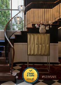 a staircase with a dresser in a room at Valeriana Exclusive GuestHouse in Évora