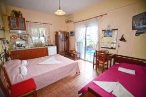 a bedroom with a white teddy bear sitting on a bed at Ikaria Studios in Manganítis