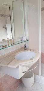 a bathroom with a sink and a mirror at Hotel Britannia Rimini Marina centro in Rimini +16 photos
