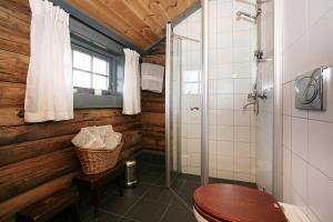 a bathroom with a toilet and a glass shower at Korsholmen - by Classic Norway Hotels in Karvåg +12 photos