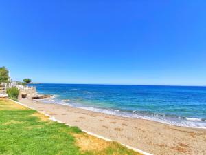 a beach with the ocean on a sunny day at Thalia deco City & Beach Hotel in Hersonissos