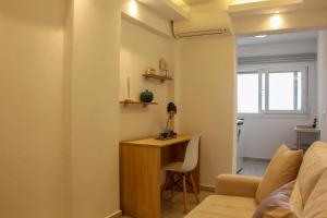 salon z biurkiem i kanapą w obiekcie Thea-tro Apartments w mieście Limenas
