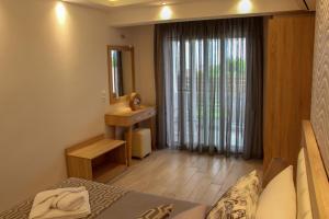 a bedroom with a bed and a sink and a mirror at Thea-tro Apartments in Limenas