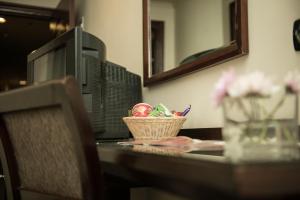 a table with a basket of pens and a mirror at Cherry Maryski Hotel in Alexandria