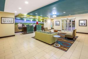 a lobby of a hospital with a couch and chairs at La Quinta by Wyndham Floresville in Floresville