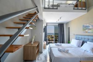 a bedroom with two beds and a staircase at Alos Utopia in Stavros