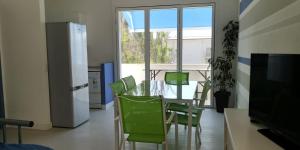 アルカモ・マリーナにあるCasa Mimosaのダイニングルーム(テーブル、緑の椅子付)