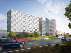 a large building with cars parked on the side of a road at Quality Hotel Arlanda XPO in Arlanda