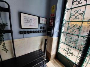 a waiting room with a bench next to a window at Inn Faro - Casa Amarela - Guest House in Faro