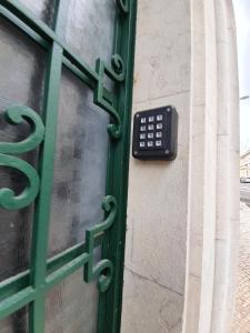 a door with a remote control attached to a window at Inn Faro - Casa Amarela - Guest House in Faro