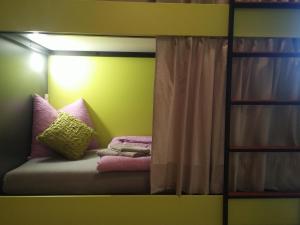 a room with a bed with pillows and a mirror at Hostel **Casa del Sole** in Klenovica