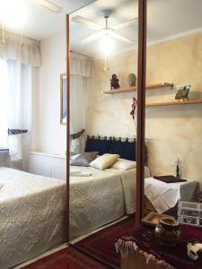 a mirror in a bedroom with two beds at CASA Lux in Serravalle Pistoiese