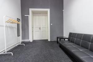 a living room with a couch and a white door at Hostel Best time in Lviv