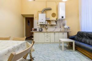 a living room with a couch and a kitchen at Hostel Best time in Lviv