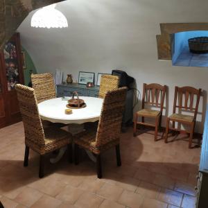 a dining room with a white table and chairs at Appartamento Il Campanile in Muro Leccese