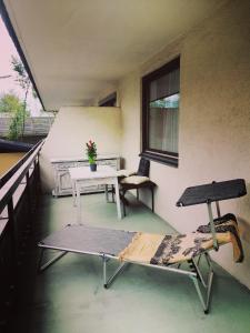 a room with a table and chairs on a balcony at Apartment Angelika in Zell am See