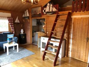 a living room with a staircase in a cabin at Ferienhaus Möwenherz in Pruchten