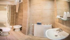 a bathroom with a white sink and a toilet at Galleria Frascati Rooms and Apartment in Frascati +33 photos