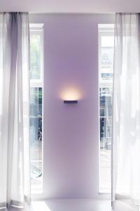 a white room with two windows and a door at Hotel 171 in Rotterdam