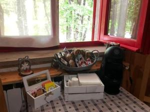 a kitchen with a counter with boxes and windows at B&B Villa Olimpia in Prati di Tivo