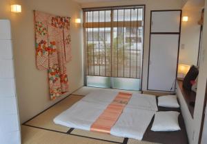 a room with a bed and a window at La Passione Boutique B&B in Naha
