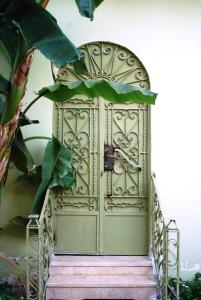 a green door with stairs leading up to it at Arabesque House Apartment in Luxor