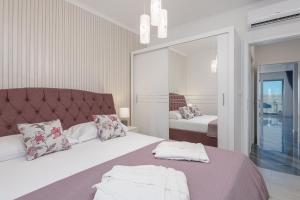 Postel nebo postele na pokoji v ubytování Apartments Cosmopolit