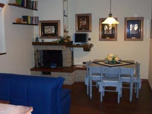 a living room with a table and a fireplace at Casa Daniela in Pietrasanta