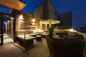 a rooftop deck with a table and chairs and an umbrella at Europark in Barcelona