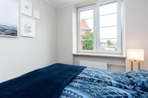 Posteľ alebo postele v izbe v ubytovaní Riverside Apartment Targ Rybny