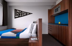 a bedroom with a bed and a sign that says lets staynm at The Social Hub The Hague in The Hague