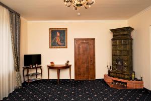 a room with a door and a television and a table at Boutique Hotel Villa P in Uzhhorod