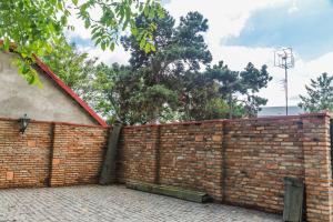 a brick fence in front of a house at Boutique Hotel Villa P in Uzhhorod