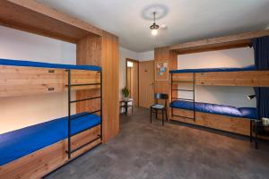 a room with two bunk beds in it at Chalet Turbina in Zermatt