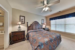 a bedroom with a bed and a ceiling fan at Myrtlewood Condos in Myrtle Beach