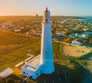 an aerial view of a lighthouse with a town in the background at Balconada in La Paloma