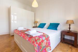 リスボンにあるSaldanha Concept by Homingのベッドルーム(白いベッド、青い枕付)